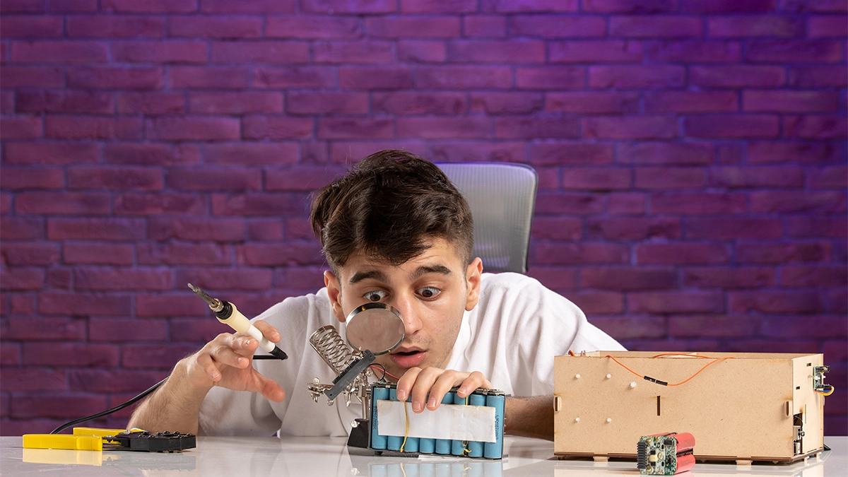 Boy assembling hardware with code focus