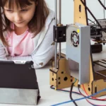 Girl making Cardboard Code DIY